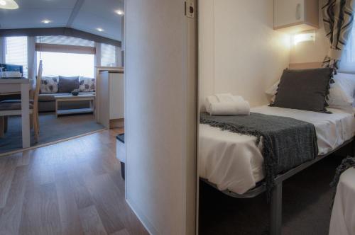 安姆罗斯Ty Moselle 12 - 2 Bedroom Holiday Home - Amroth的一间卧室设有一张床和一间客厅。