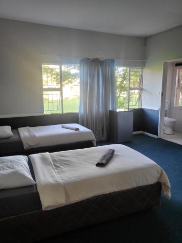 埃尔默洛Legends Lodge的酒店客房设有两张床和窗户。