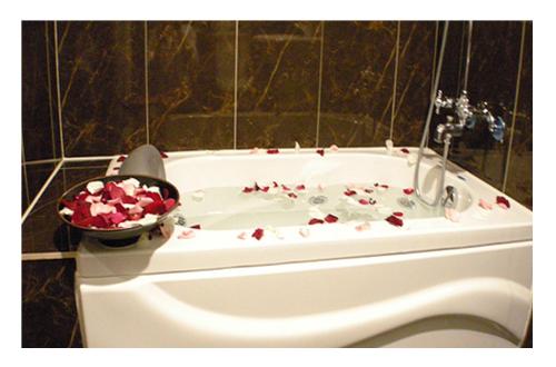 基隆馥嘉商务旅馆 的浴缸上放着一碗玫瑰