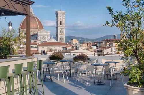 佛罗伦萨NH Collection Palazzo Gaddi的一个带桌椅的庭院,享有城市美景