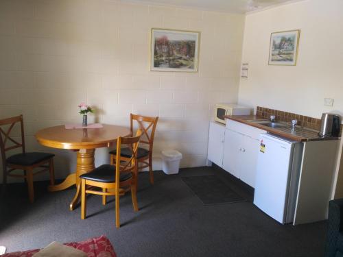 莱文Amble Inn Motel的小房间设有桌子和厨房