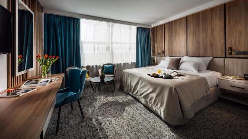 萨格勒布Grand Hotel Zagreb的配有一张床和一张书桌的酒店客房