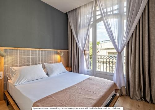 巴塞罗那Gòtic by The 5ve Soul的一间卧室设有一张床和一个大窗户