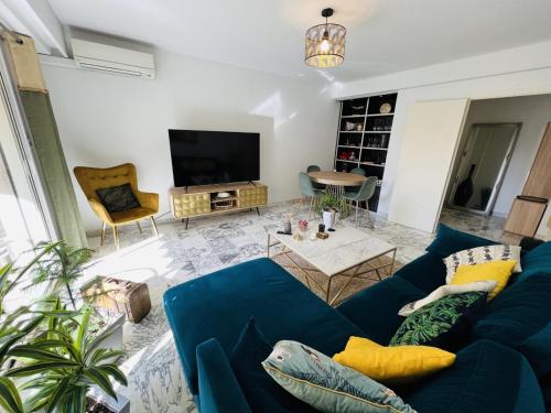 尼斯John Homestay Room in Nice的客厅配有蓝色的沙发和电视