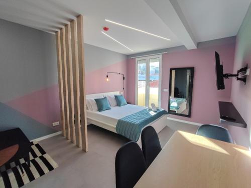 丰沙尔Social Lodge - Happiness的一间卧室配有一张床和粉红色的墙壁