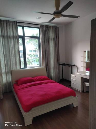 塞贝维Summer Glades, Cyberjaya的一间卧室配有一张带红色床单的床和一扇窗户。