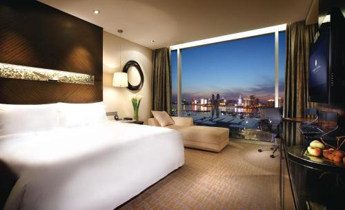 青岛青岛海尔洲际酒店（奥林匹克帆船中心内）的一间酒店客房,设有一张大床和一个大窗户