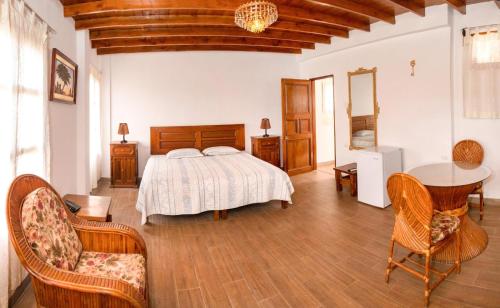 伊察Bodega el Huarango的卧室配有一张床和一张桌子及椅子