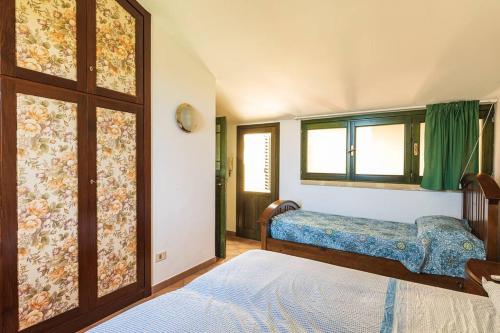 切法卢Casa al mare dei 7 Emiri的一间卧室设有两张床和窗户。