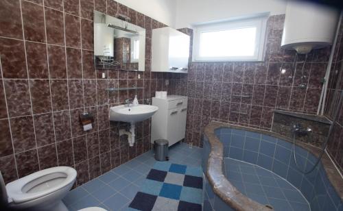 塞尔察Villa Adriana的浴室配有卫生间、盥洗盆和浴缸。