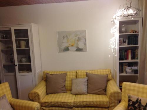 霍伊塞尔恩Schwarzwaldhut的客厅配有带枕头的黄色沙发