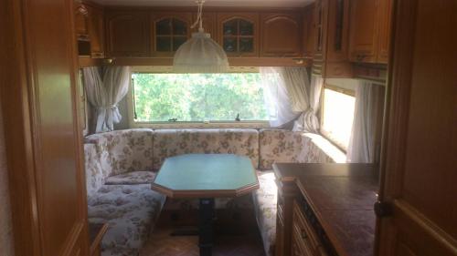 尤尔马拉Summer bungalo trailer的客厅配有沙发和餐桌