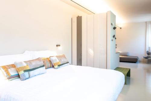 瓦拉泽苏里高酒店的白色卧室配有白色的床和枕头