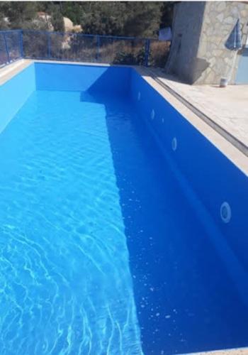 乌沙克Modestus pansiyon otel的蓝色海水大型蓝色游泳池