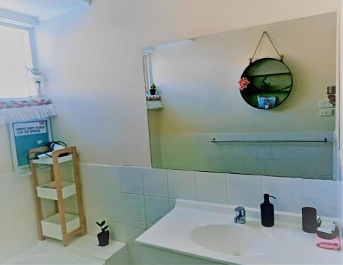 卡尔古利2BR house in West Lamington的一间带水槽和镜子的浴室
