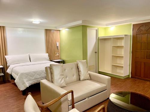 达古潘Damara Hotel at Ciudad Elmina的客厅配有床和沙发