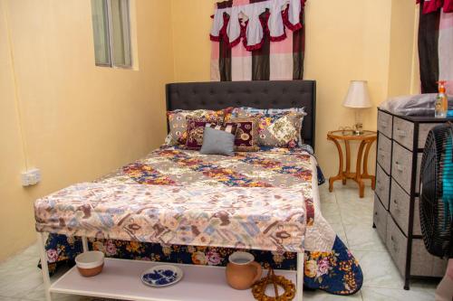 Arnos ValePRI Guest House的一间卧室配有床和桌子,上面有杯子
