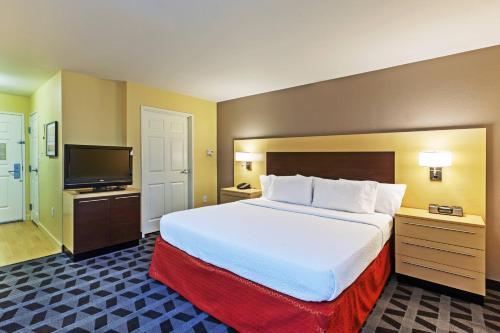 布罗肯阿罗万豪塔尔萨断箭广场套房酒店的一间酒店客房,配有一张大床和一台平面电视