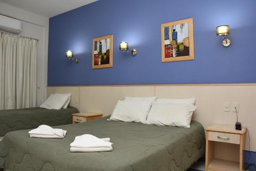 恩卡纳西翁亚瑟香巴拉酒店的酒店客房,配有两张带毛巾的床