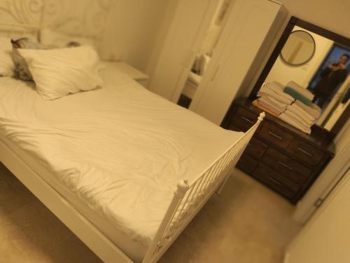 荷兹利亚BMarina vaction rentals的卧室内的一张未铺好的床,配有镜子