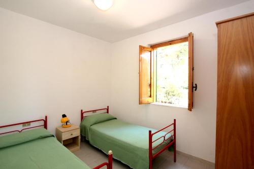 维耶斯泰Residence Delfino的带窗户的客房内设有两张单人床。