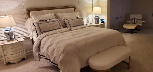 弗雷德里克528 Carroll Walk Avenue的白色卧室配有一张大床和椅子