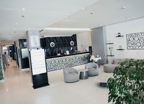 马斯喀特Best Western Premier Muscat的大堂配有沙发、椅子和柜台