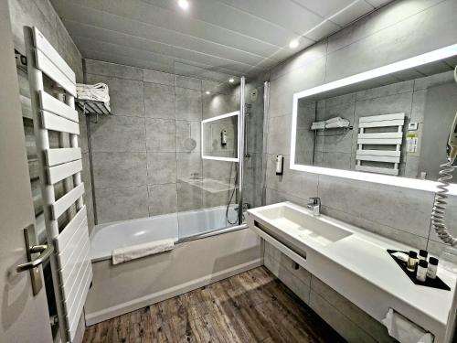 鲁伊萨塞Domaine de la Forêt d'Orient, Logis Hôtel, Restaurant, Spa et Golf的一间带水槽、浴缸和镜子的浴室