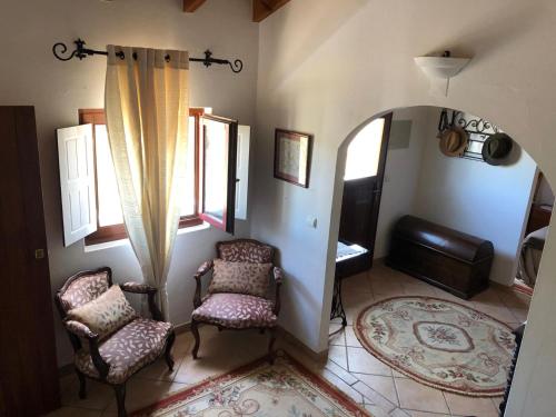 里戈尔Casa da Samouqueira的客厅配有两把椅子和窗户