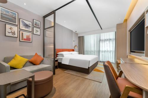 深圳深圳南山科技园希尔顿惠庭酒店的酒店客房,配有床和沙发
