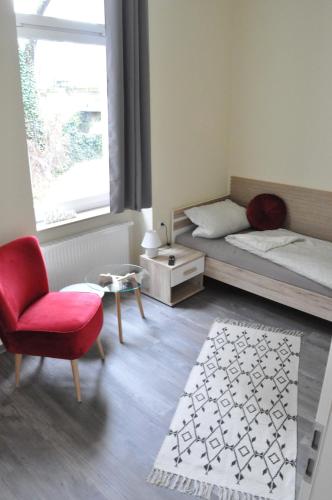 爱尔福特ElisaBett Erfurt - Eine Wohnung bis 6 Personen - 4 Schlafzimmer und 2 Bäder的一间卧室配有一张床、一把椅子和一张桌子