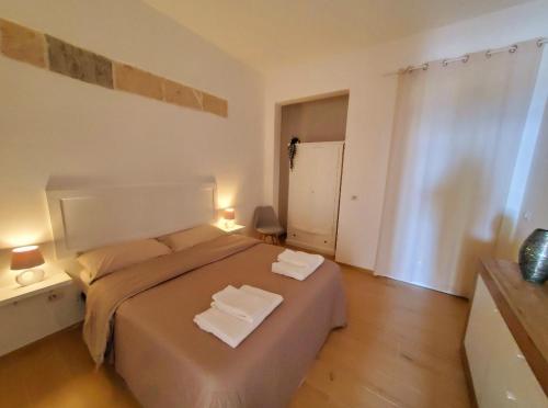 纳尔多SEA FRONT, Allegria, Santa Maria al Bagno的一间卧室配有一张大床和两条毛巾