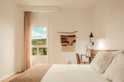 拉梅戈兰莫格酒店的一间卧室配有一张床、一张书桌和一个窗户。