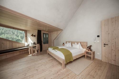 圣贾科莫Bühelwirt的一间卧室设有一张大床和一个大窗户