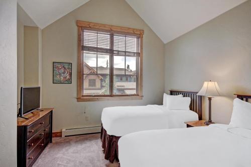 布雷肯里奇Mountain Thunder M204的酒店客房设有两张床和窗户。