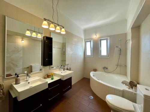 雷夫卡达镇Apollon Paian , Luxury Nature Relax的浴室配有2个盥洗盆、浴缸和大镜子