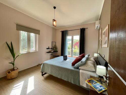 雷夫卡达镇Apollon Paian , Luxury Nature Relax的一间卧室配有一张带笔记本电脑的床