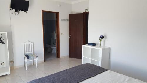 阿托吉亚达巴莱亚Alojamento Dona Inês de Castro的一间卧室配有一张床,浴室设有卫生间