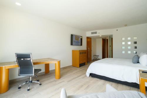托雷翁Real Inn Torreon的一间卧室配有书桌、一张床和一张书桌