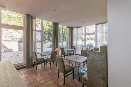 巴特尚道托斯卡尼-阿尔贝噶酒店的用餐室设有桌椅和窗户。