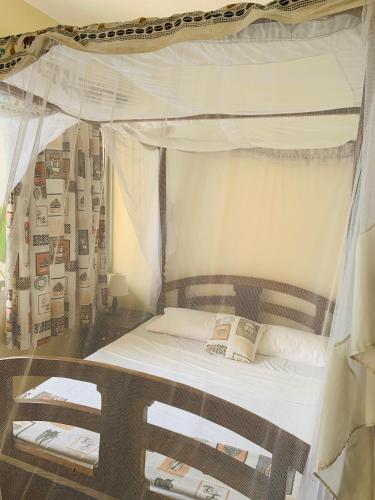 尼亚利Ltorec的一间卧室配有一张天蓬床,里面装有两本书