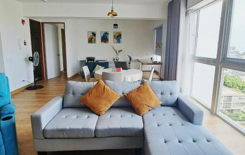 利马VK Loft - Apartamento en Miraflores的客厅配有带枕头的蓝色沙发