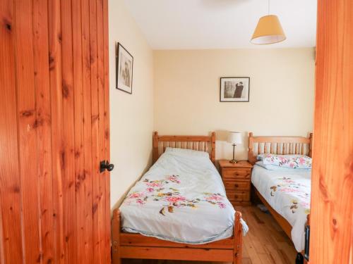 CastlerichardThe Granary的一间卧室设有两张单人床和一扇木门