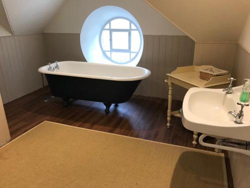 The Bothy, Gallin, Glenlyon, Perthshire的一间带大浴缸和水槽的浴室