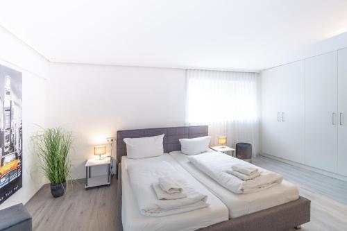 阿尔高内的伊门施塔特Haus Alpsee的一间卧室配有一张大床和两条毛巾