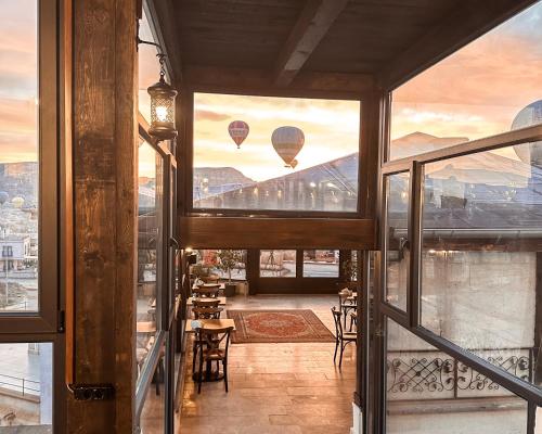 格雷梅Osmanli Cappadocia Hotel的阳台设有两个空中热气球