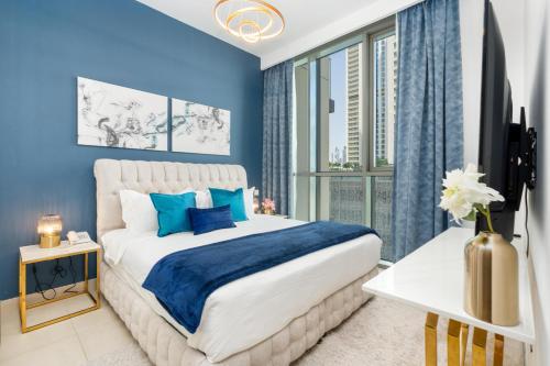 迪拜Ultimate Stay / Directly Connected to Dubai Mall的蓝色的卧室设有一张大床和一个窗户