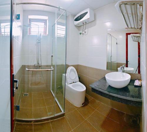 Nam ÐịnhRuby Hotel的浴室配有卫生间、盥洗盆和淋浴。