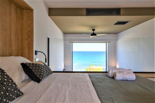 阿特米达CUBES ON THE BEACH Athens Airport的一间卧室设有一张床,享有海景