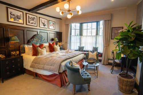 赫特福德索尔兹伯里纹章酒店的一间卧室设有一张大床和一个大窗户